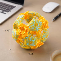 A yellow and light blue geometric puzzle ball