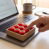 A hand points at a small wooden tray