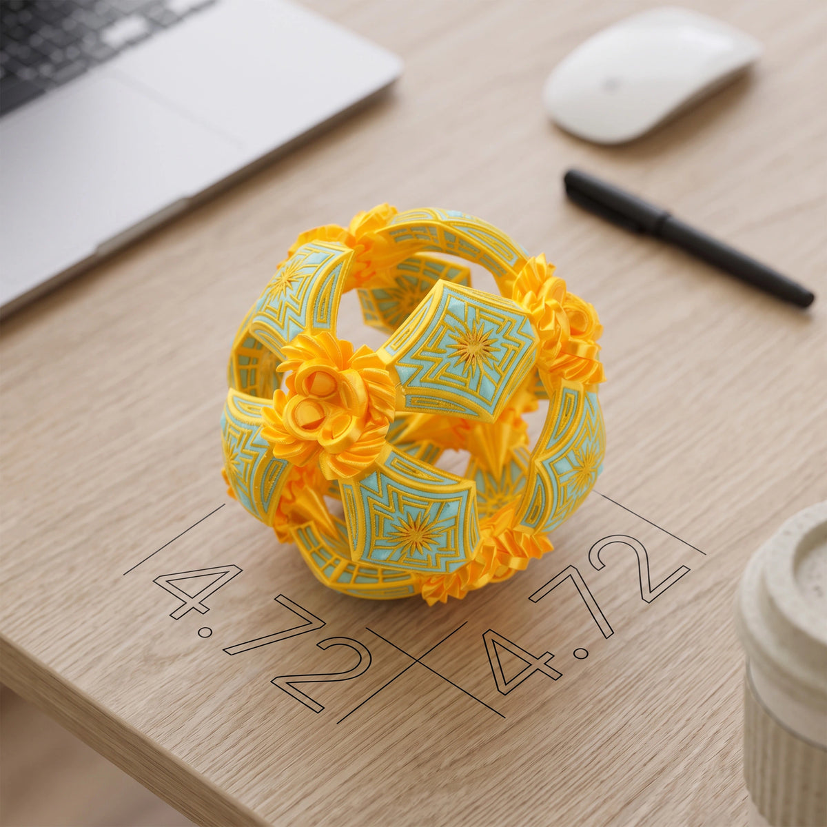 A yellow and light blue geometric flower-shaped ornament