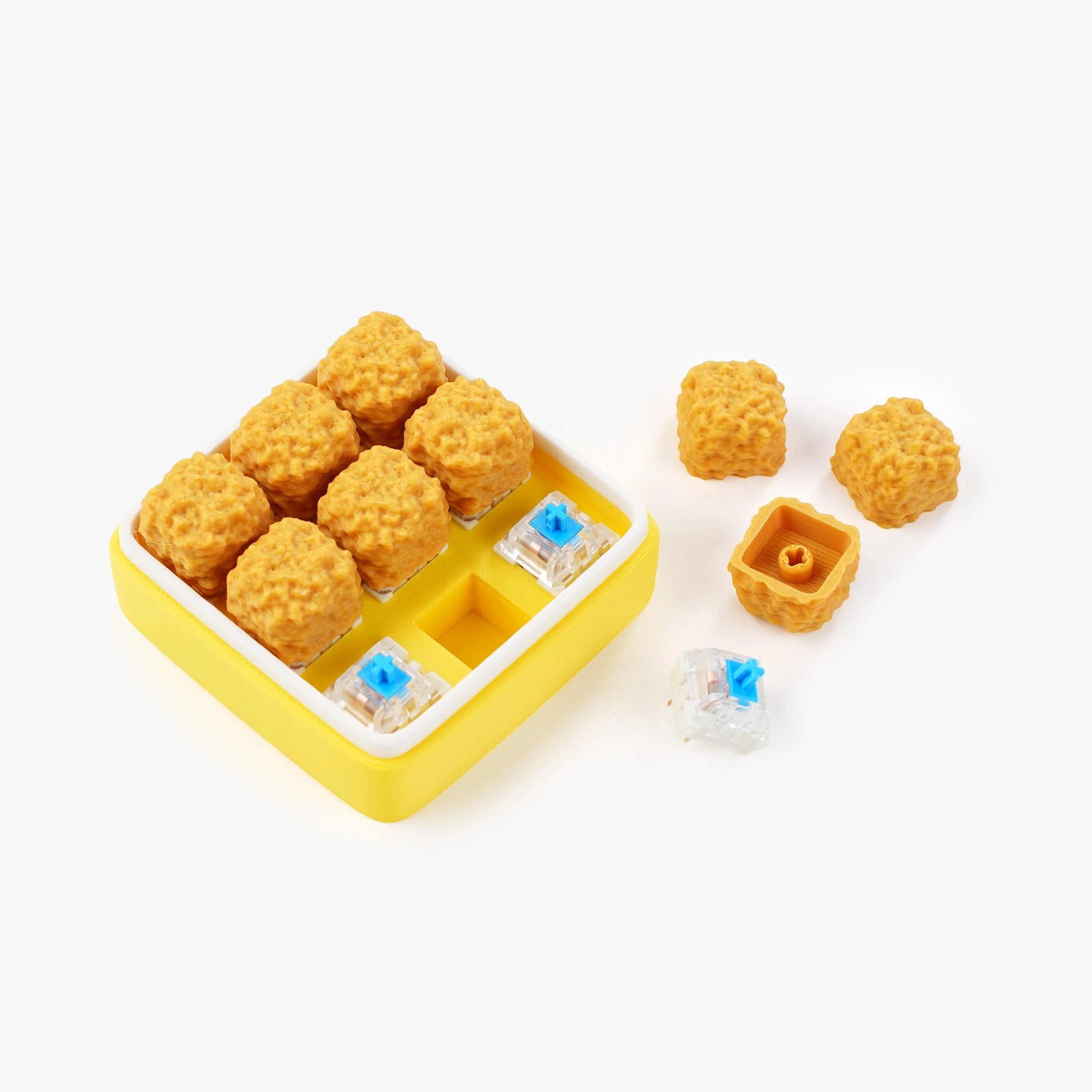 A yellow and white mechanical keyboard switch tray