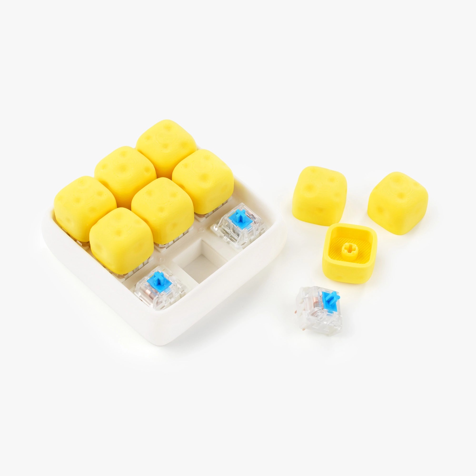 Yellow cheese-shaped mechanical keyboard switch caps and clear switch blanks