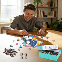 Man assembling Snoopy wooden puzzle on a table.