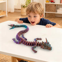 Boy playing with colorful 3D printed articulated Dragon