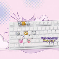 Tom & Jerry character keycaps on a white keyboard